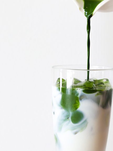 Matcha poured over milk in a glass