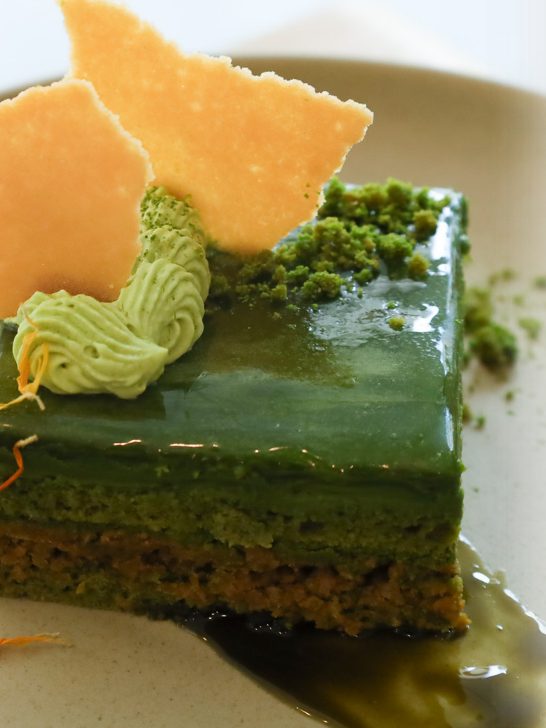 A matcha layer cake with a tuile and piped cream