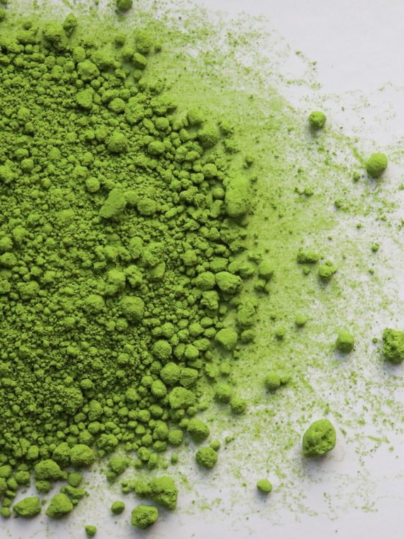Matcha powder sifted onto a pale surface